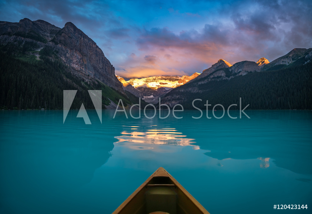 Viewing snowy mountain in rising sun from a canoe from Wallmural